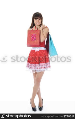 beautiful woman in a full-length with shopping bags. Isolated on white background