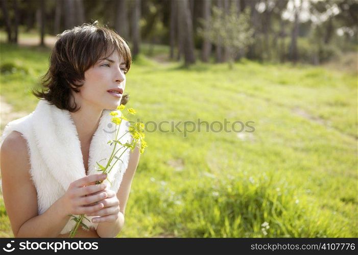 beautiful woman in a spring landscape, yellow flowers