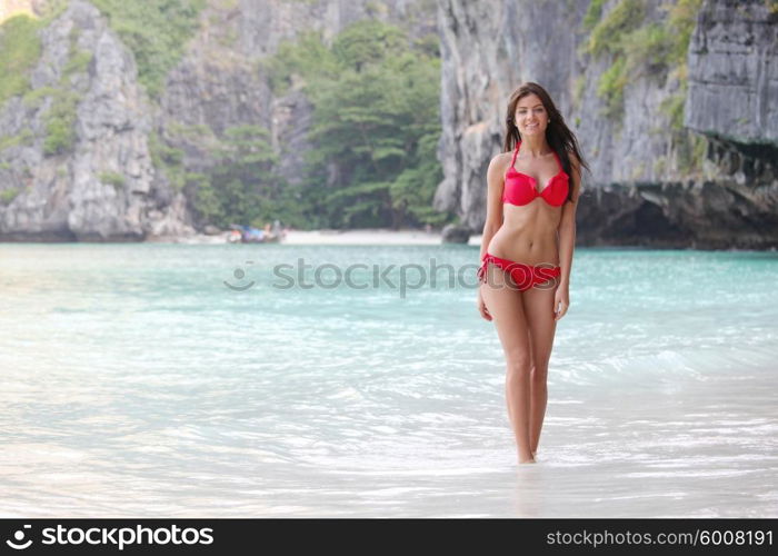 Beautiful woman in bikini enjoy walking on beach at Maya bay, Thailand