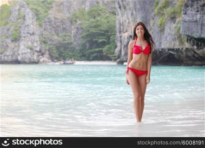 Beautiful woman in bikini enjoy walking on beach at Maya bay, Thailand