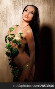 Beautiful woman in bikini with tropical leaves