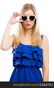 Beautiful woman in blue dress using sunglasses with a hearth shape, isolated over white background