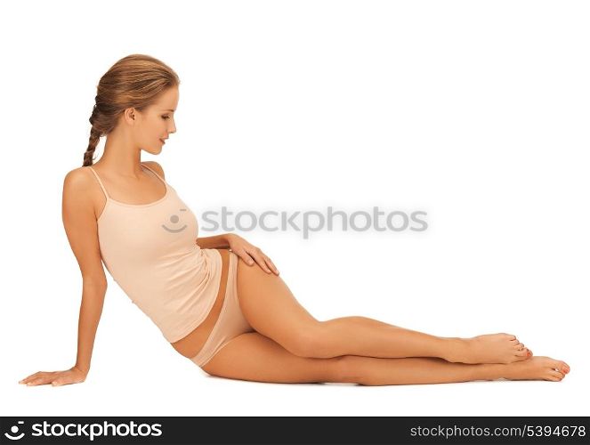 beautiful woman in cotton underwear touching her legs