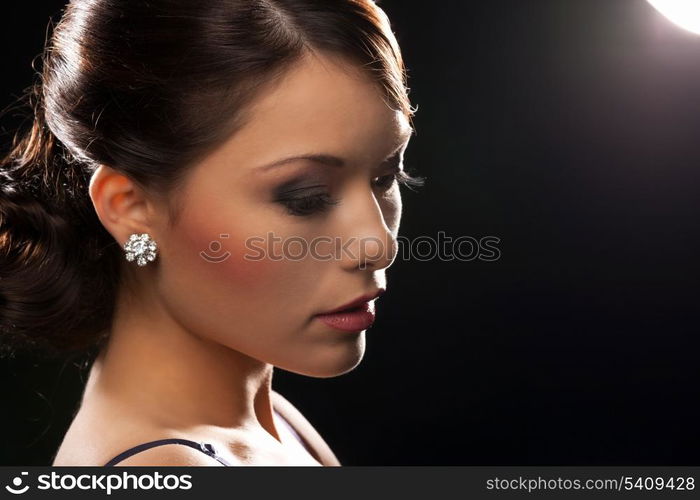 beautiful woman in evening dress wearing diamond earrings