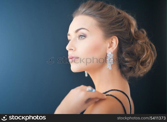 beautiful woman in evening dress wearing diamond earrings