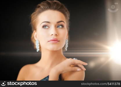 beautiful woman in evening dress wearing diamond earrings