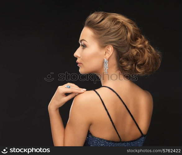 beautiful woman in evening dress wearing diamond earrings