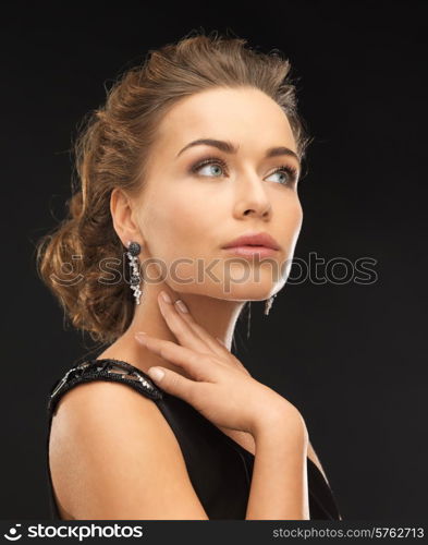 beautiful woman in evening dress wearing diamond earrings