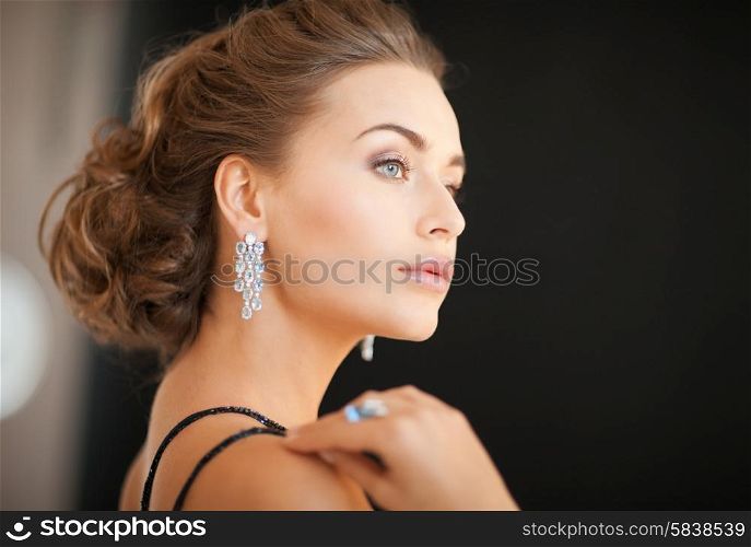 beautiful woman in evening dress wearing diamond earrings
