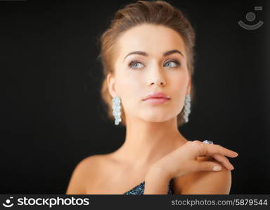 beautiful woman in evening dress wearing diamond earrings