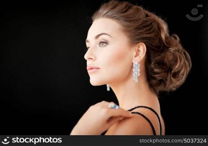 beautiful woman in evening dress wearing diamond earrings. woman with diamond earrings
