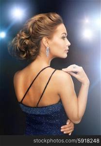 beautiful woman in evening dress wearing diamond earrings. woman with diamond earrings
