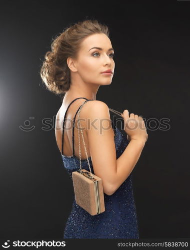 beautiful woman in evening dress with small bag