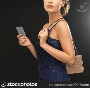 beautiful woman in evening dress with small bag