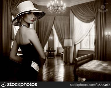 Beautiful woman in hat in luxury room.
