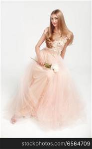 Beautiful Woman in Lace Wedding Dress. Beautiful Lady with Healthy and Beauty Hair. Woman with a peony
