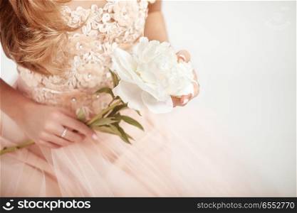 Beautiful Woman in Lace Wedding Dress. Woman with a peony. Wedding Decoration