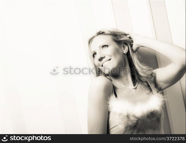 Beautiful woman in lingerie and nightdress posing, tinted black and white image
