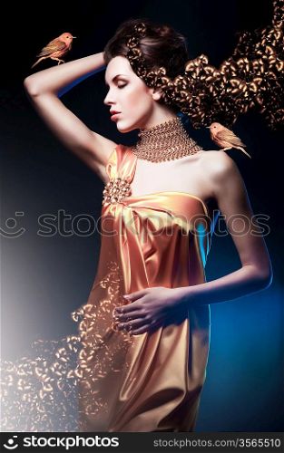 beautiful woman in long dress with jewelry and birds