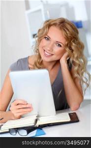 Beautiful woman in office using digital tablet