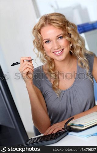 Beautiful woman in office working on desktop computer