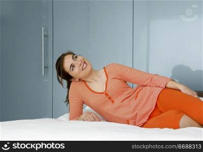 Beautiful woman in pajama on bed and relaxing