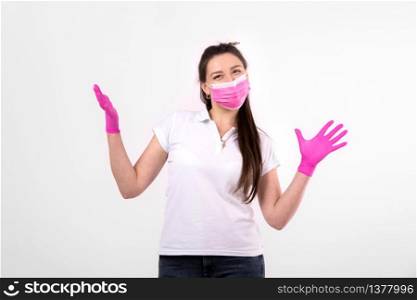 beautiful woman in pink medical mask on a white background. woman wearing medical mask. protection against influenza virus. ear with protective face mask at home. stop coronavirus. beautiful woman in pink medical mask on a white background. woman wearing medical mask. protection against influenza virus. ear with protective face mask at home. stop coronavirus.