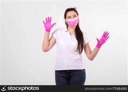 beautiful woman in pink medical mask on a white background. woman wearing medical mask. protection against influenza virus. ear with protective face mask at home. stop coronavirus. beautiful woman in pink medical mask on a white background. woman wearing medical mask. protection against influenza virus. ear with protective face mask at home. stop coronavirus.