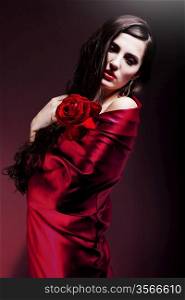 beautiful woman in red fabric with red rose