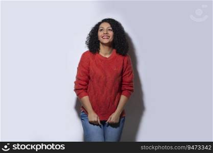 Beautiful woman in red sweater looking above with smile