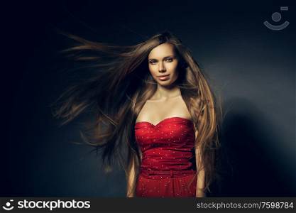 beautiful woman in red with long windy hair