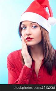 beautiful woman in santa hat on blue background