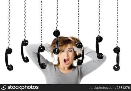 Beautiful woman in shock looking to a lot of telephones