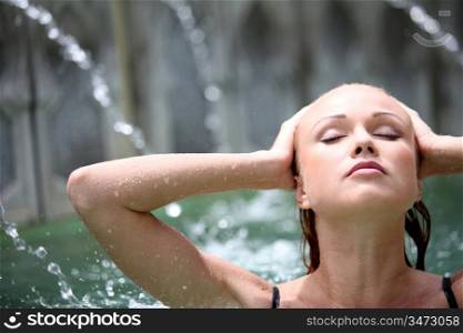 Beautiful woman in spa pool with jets