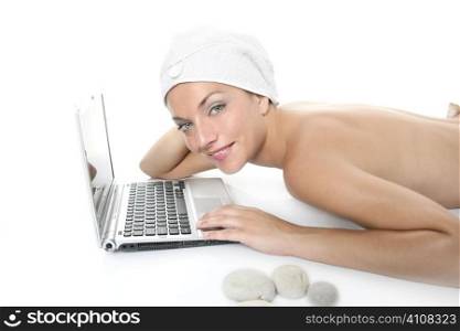 Beautiful woman in spa working with laptop computer