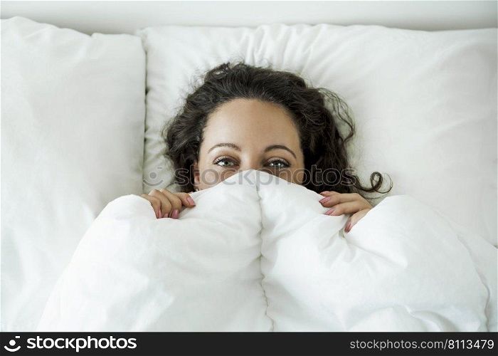 Beautiful woman in the bed and smiling by the morning