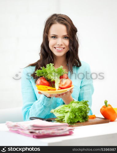 beautiful woman in the kitchen cutting vegetables