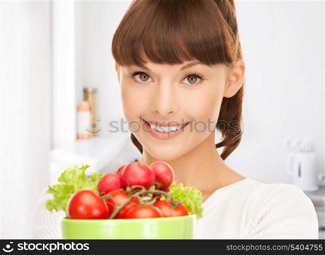 beautiful woman in the kitchen with tomatoes