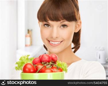 beautiful woman in the kitchen with tomatoes