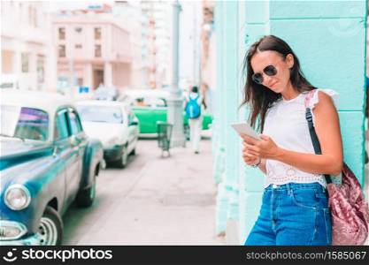 Beautiful woman in the street in old Havana on Cuba. Tourist girl in popular area in Havana, Cuba. Back view of young woman traveler