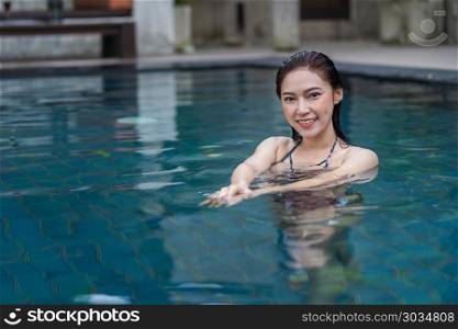 beautiful woman in the swimming pool . happy beautiful woman in the swimming pool
