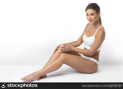 Beautiful woman in underwear. Young beautiful woman in cotton underwear sitting on white background