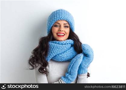 Beautiful woman in warm hat, mittens and scarf on white background. Woman in warm clothing