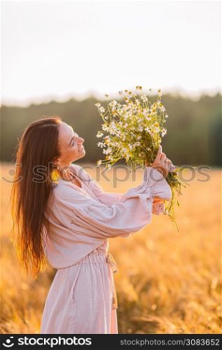 Beautiful woman in wheat field close up in sunset. Portrait of beautiful woman in summer day