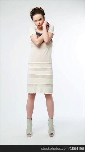 Beautiful woman in white contemporary dress. Studio shot