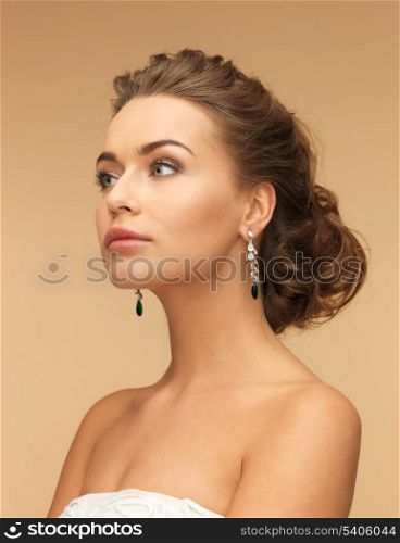 beautiful woman in white dress and diamond earrings