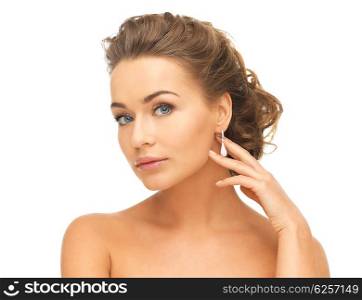 beautiful woman in white dress and diamond earrings. woman with diamond earrings