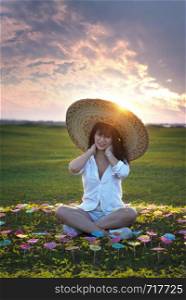 beautiful woman in white dresses and big hat with beautiful nature on sunset times. beautiful woman in white dresses