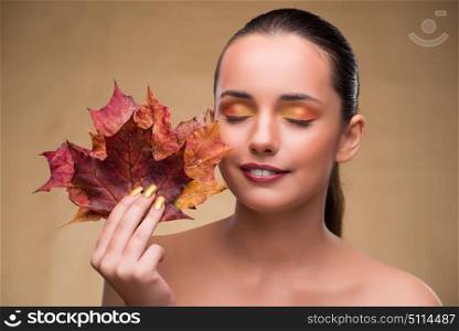 Beautiful woman in with autumn dry leaves