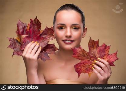 Beautiful woman in with autumn dry leaves